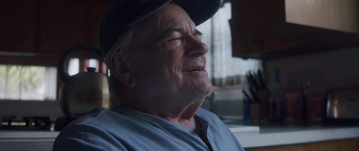 Elderly man sitting excited with happy facial expression