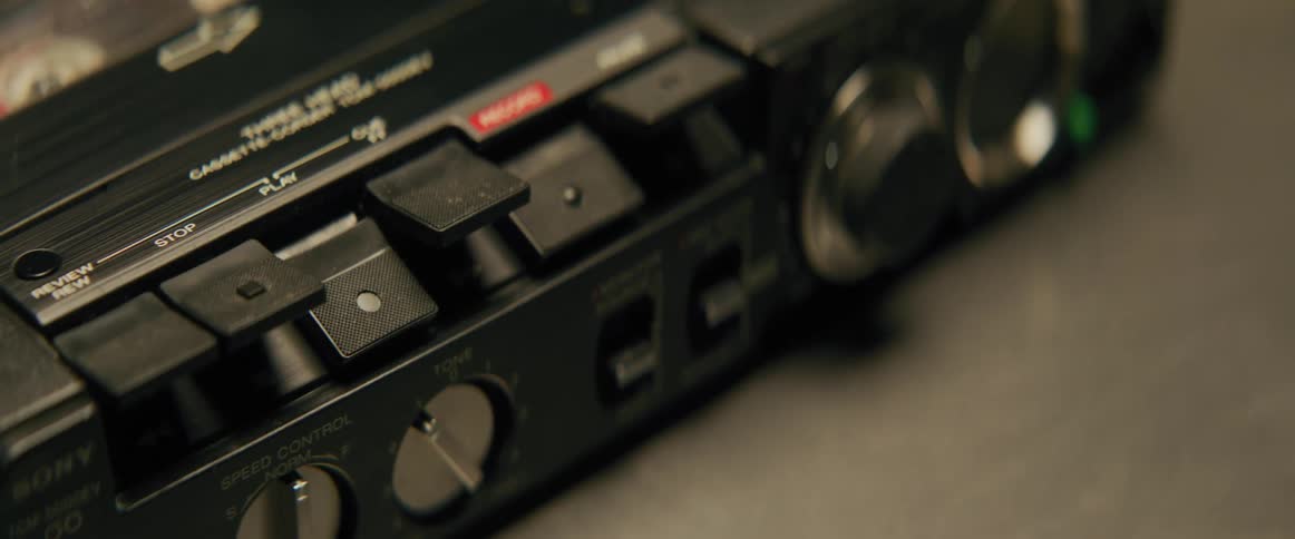 A closeup of the control panel of a vintage cassette tape player