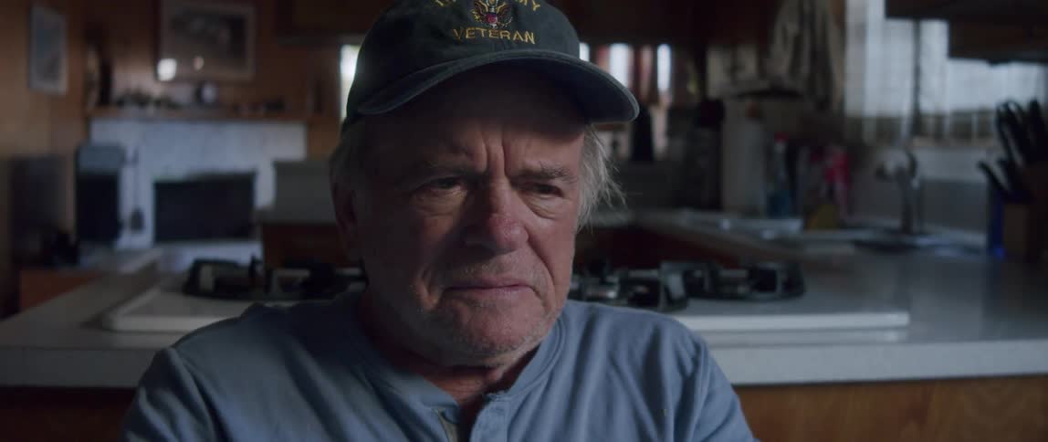 Man in cap sitting excited