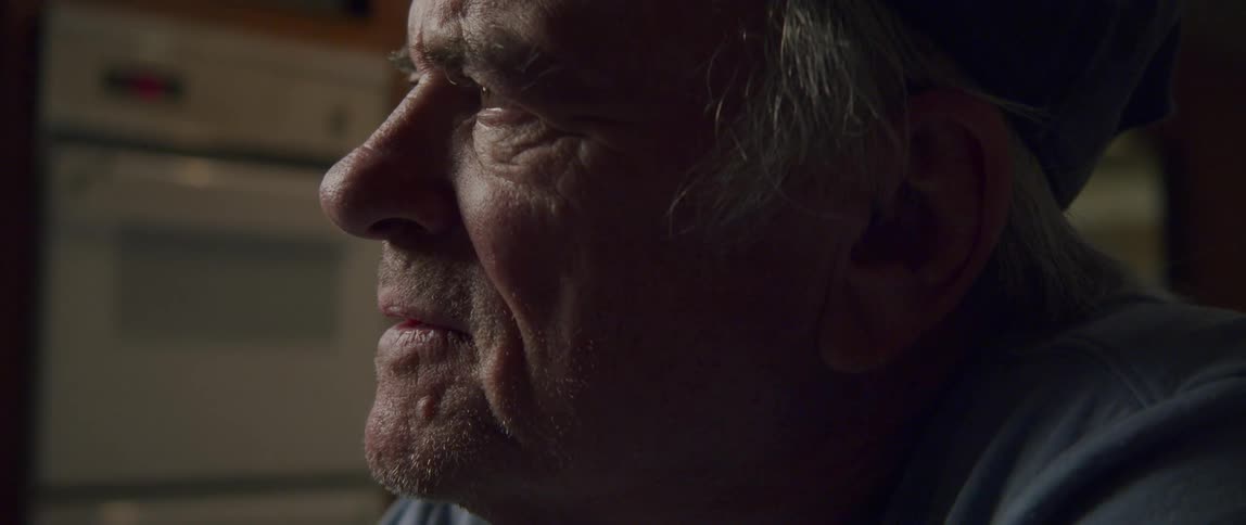 Side portrait of some elderly man smiling