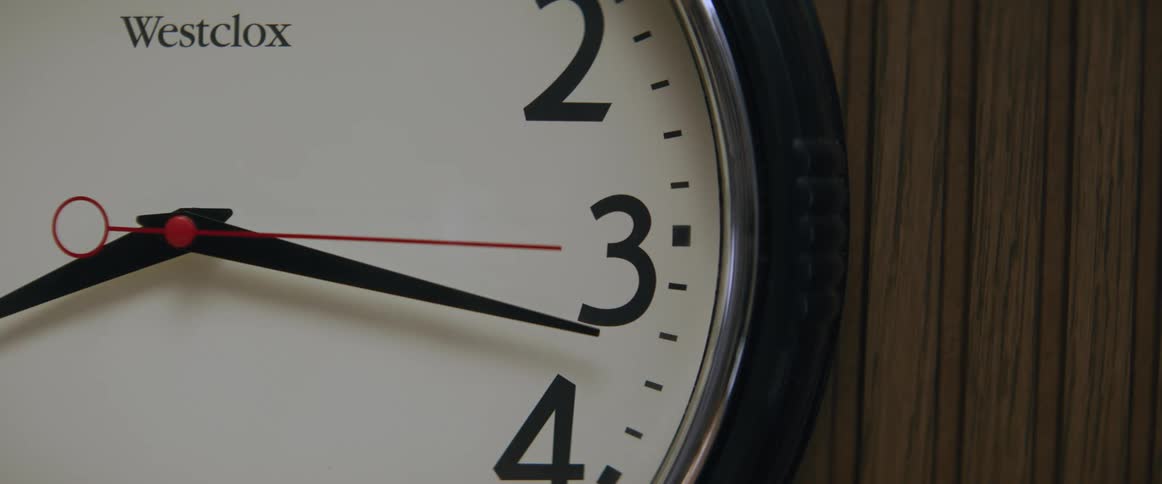 Close up of a clock on the wooden wall and the second hand moving