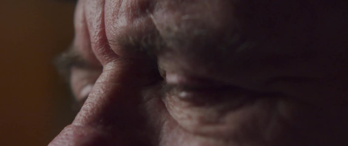 Closeup of an elderly mans eyes in emotion