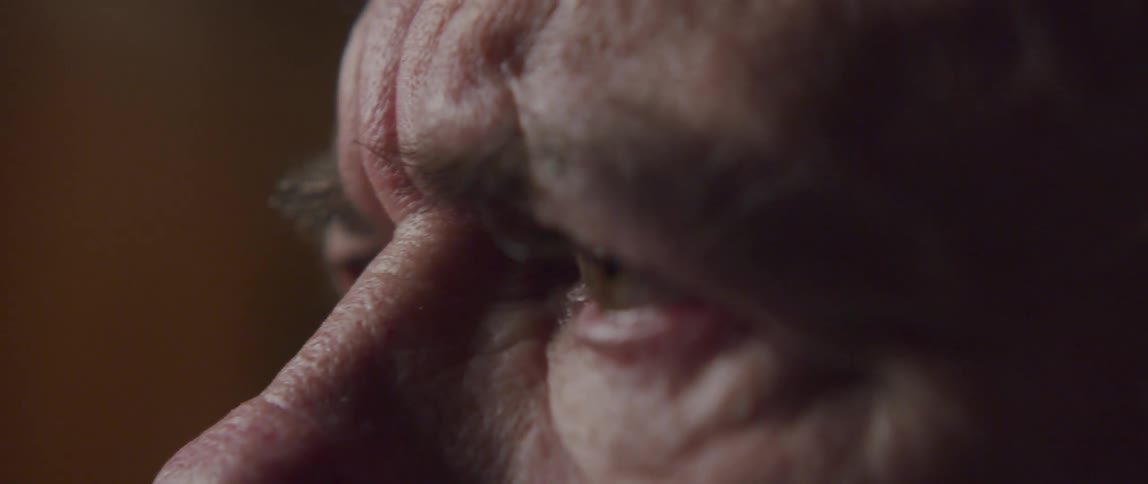 An elderly mans eyes widen in confusion