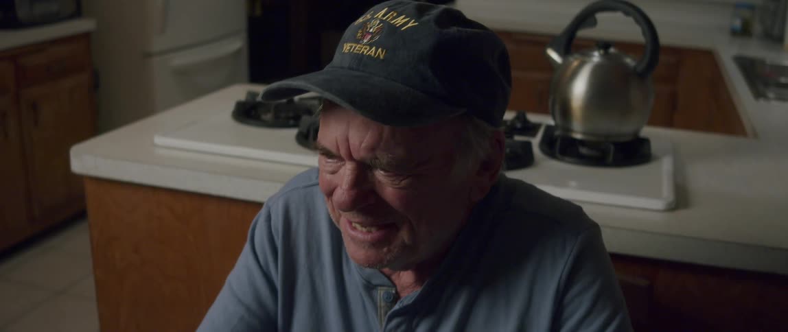 Portrait of a cheerful man sitting in the kitchen
