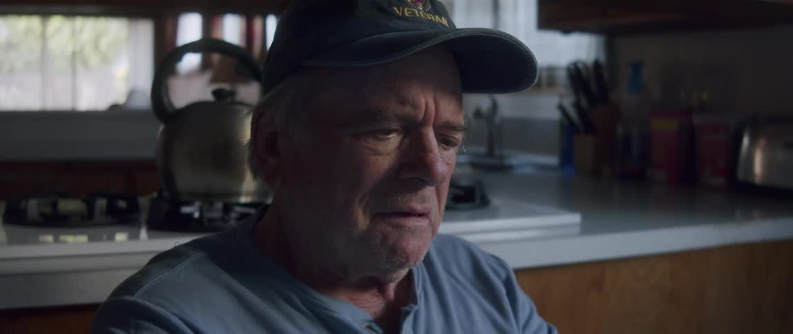 An elderly goes from shocked to happy after reading a letter