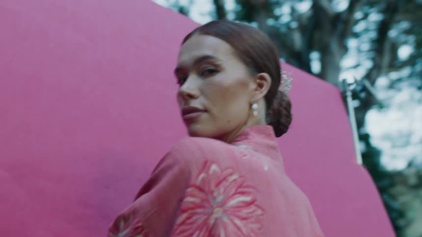 Woman model posing in a pink flowery kimono