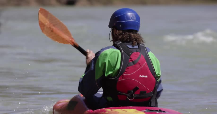 A kayaker paddles on a river