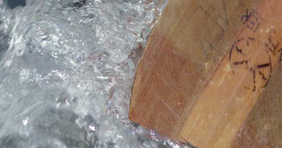 An oar hits the water