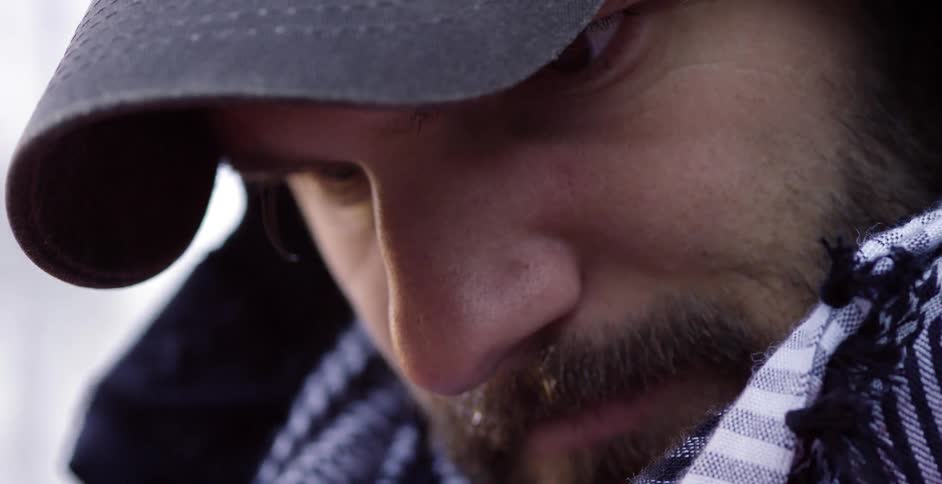Extreme close-up of a bearded man in the cold