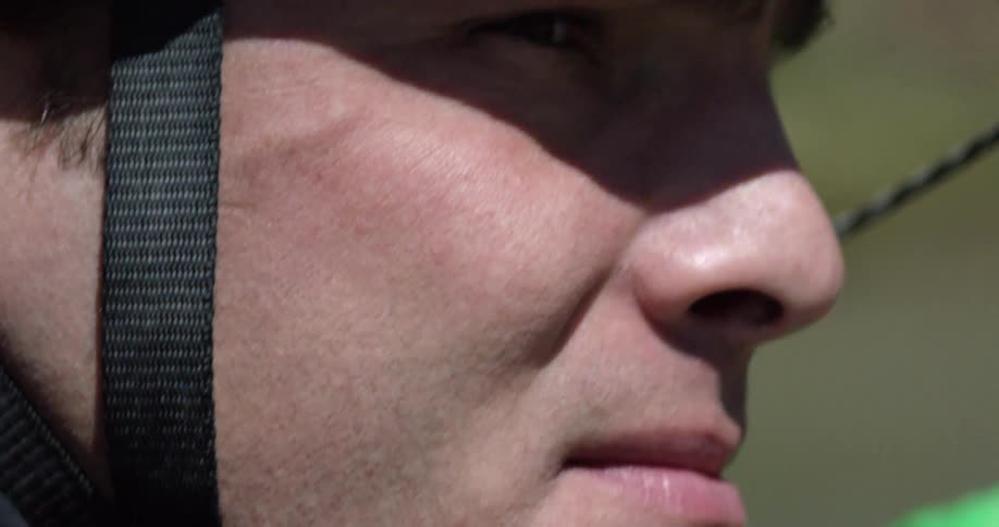 Extreme close-up of a kayaker wearing a blue helmet