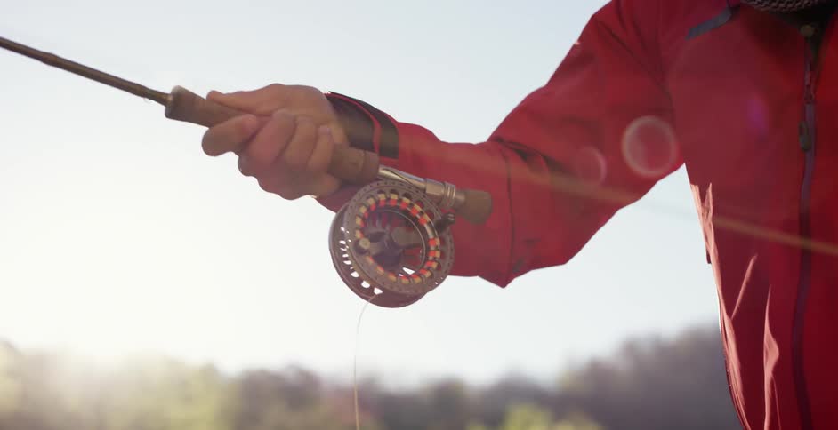 A man is fishing during the day
