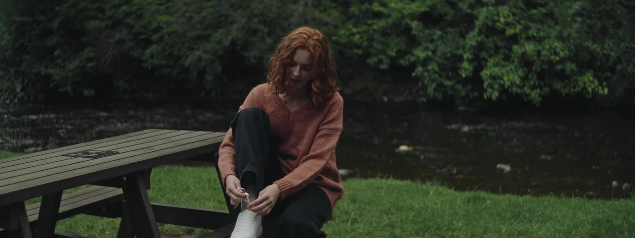 A clip of a lady lacing a shoe