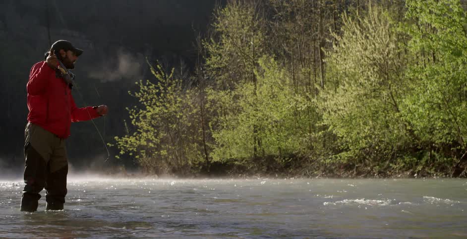 Man fly fishing on a cold day