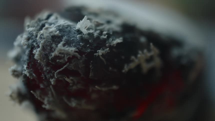 The object is burning out and giving off smoke