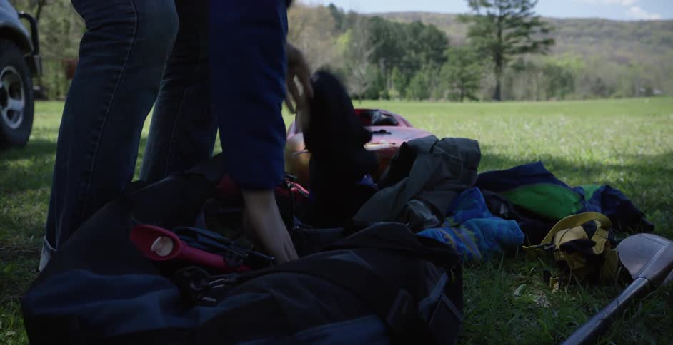 A person unpacking a bag in the wilderness