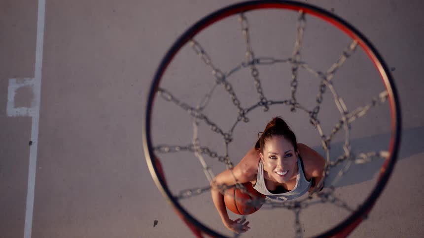 Top view of a woman on a court holding a basketball