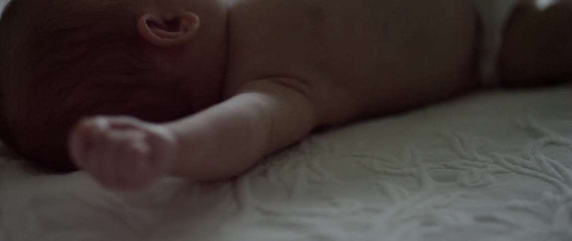 Close up of an infant lying on its back