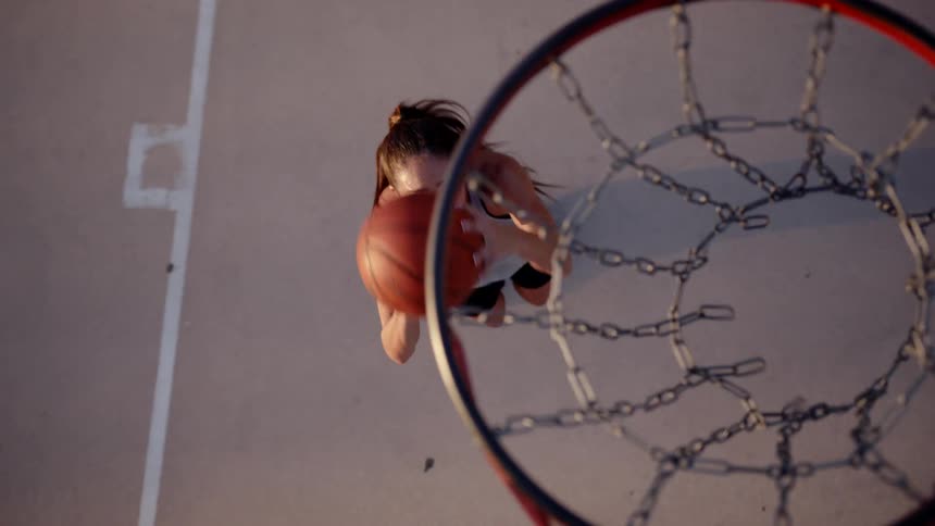 Woman on a court playing basketball