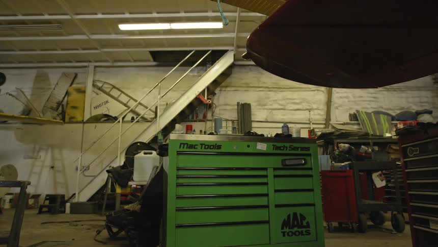 A tool storage box is shown in a garage