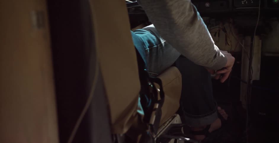 Person driving a vehicle  with their hand on the gearshift on the floor