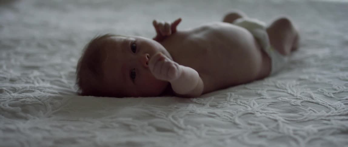 A baby is lying on the ground