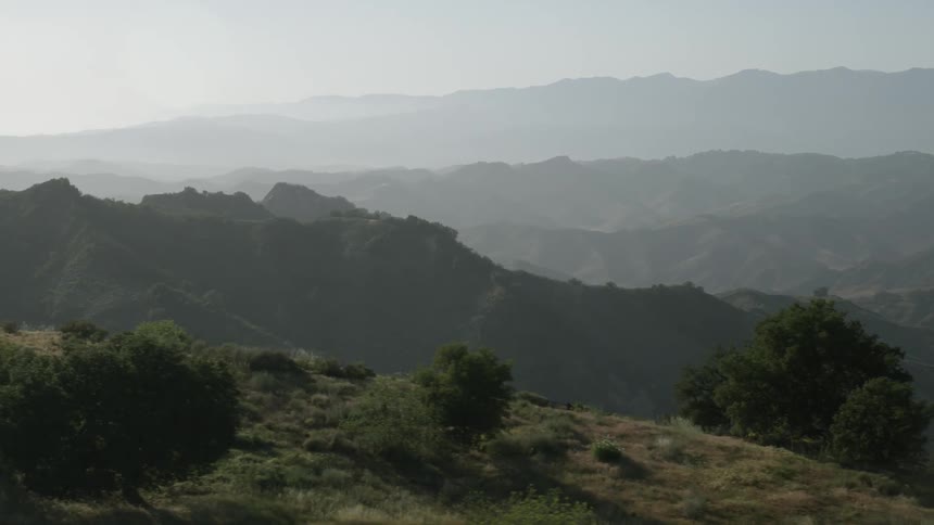 Aerial view  of green mountains on a hazy day