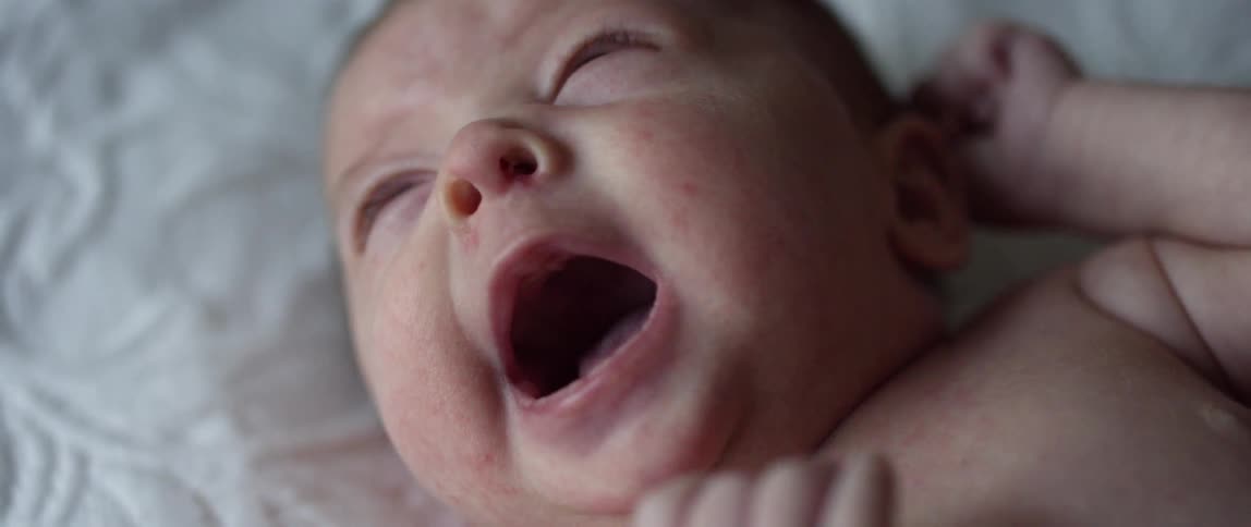 An infant child yawning