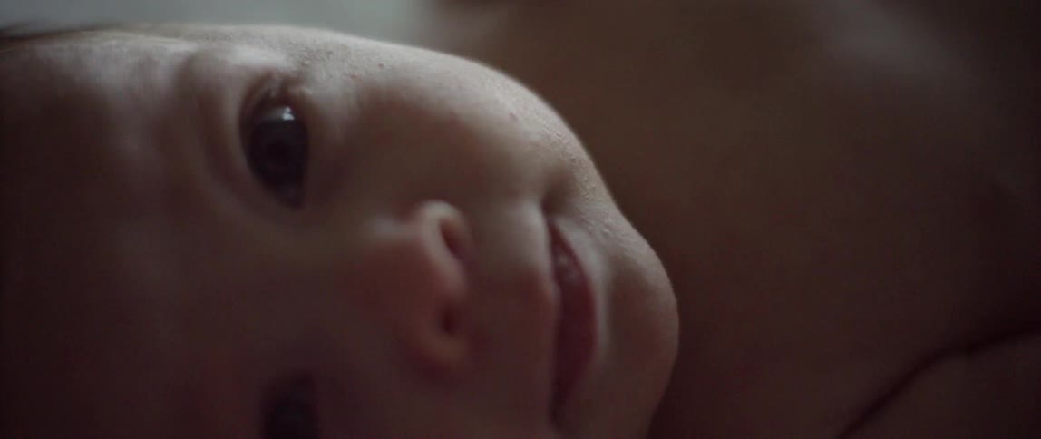Close up of an infant's face that is lying on their back