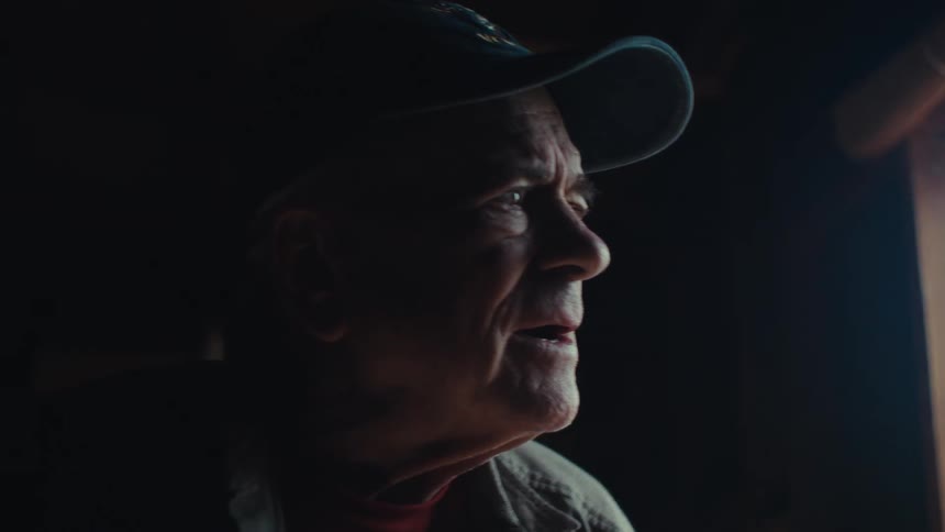 Portrait of an elderly man looking out the window
