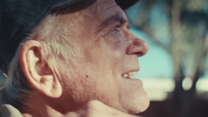 Portrait of a happy elderly man in a cap