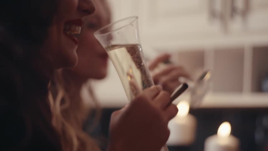 A clip of two female having a drink during a celebration