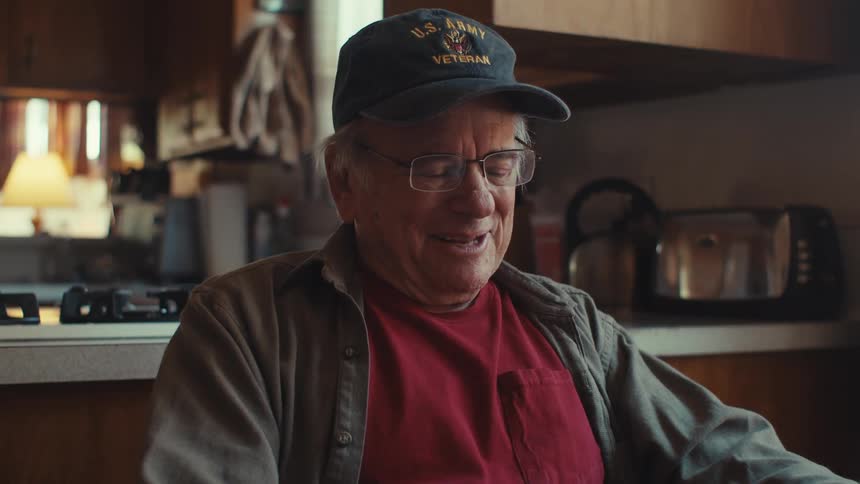 Elderly man sitting happily talking