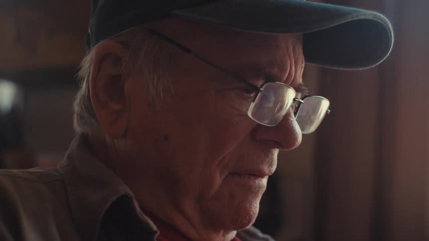 An image of an elderly man contemplating
