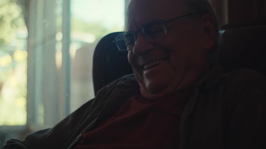 A man is laughing at home