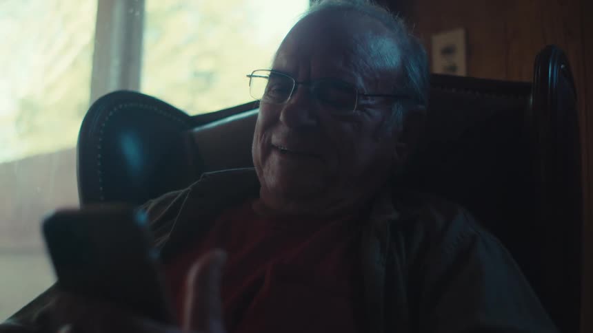 A man is talking on his cell phone at home