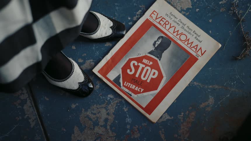 A woman sweeps and picks up a magazine