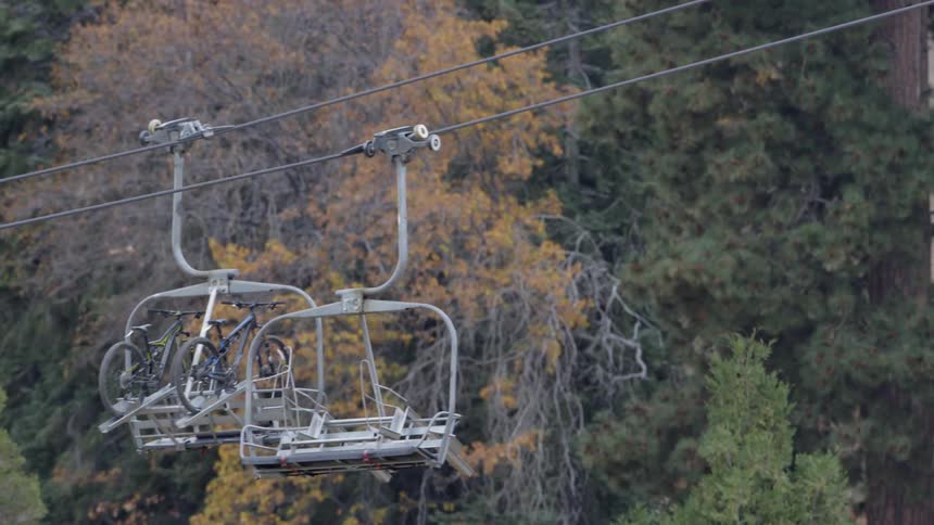 A chairlift carries two bicycles
