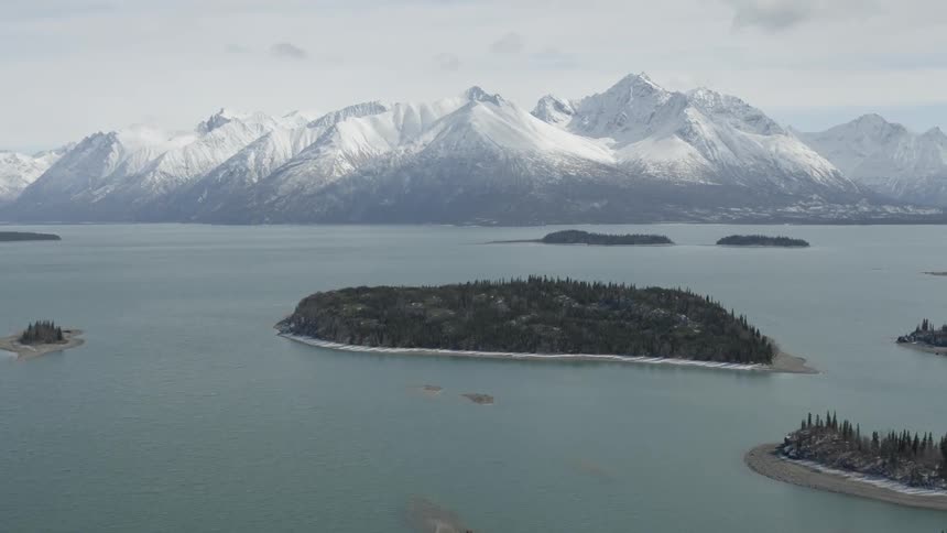 A view of a waterway that is surrounded by mountains and islands