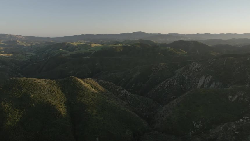 The mountain range below is covered with green