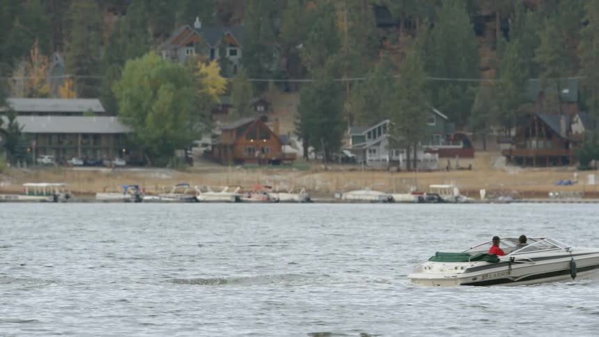 A couple of people on a boat leaving the waterway