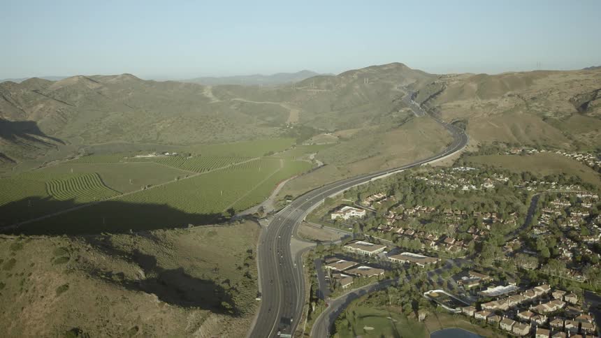 Aerial view of a road, hills and a small town