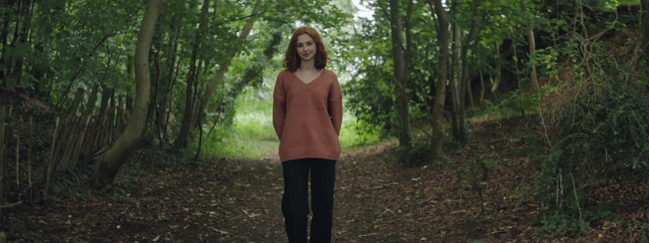 Young woman on a trail in the forest