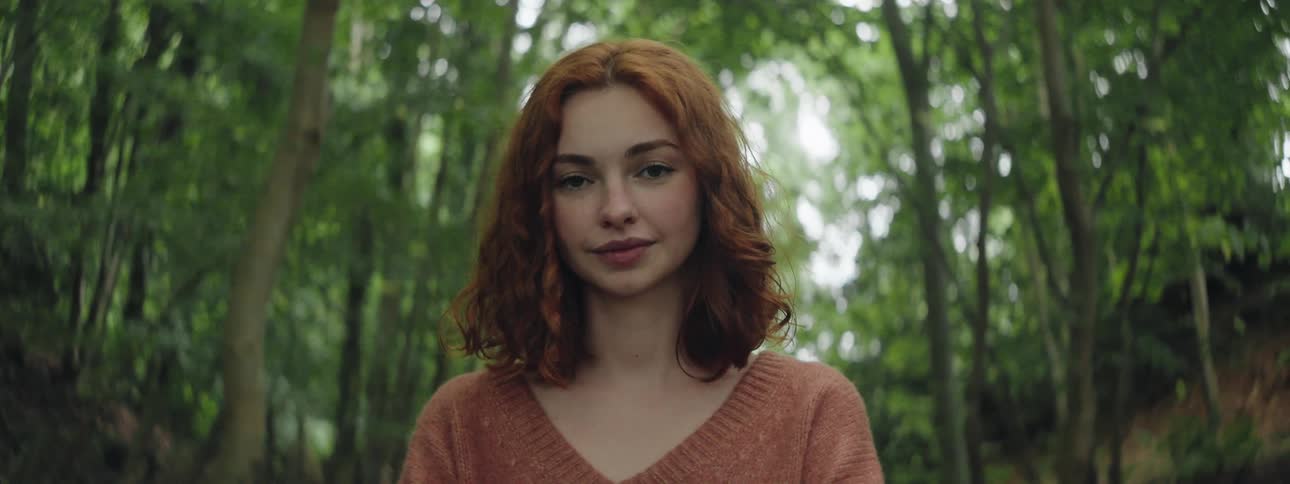 Face of a young woman in the middle of a forest in broad daylight