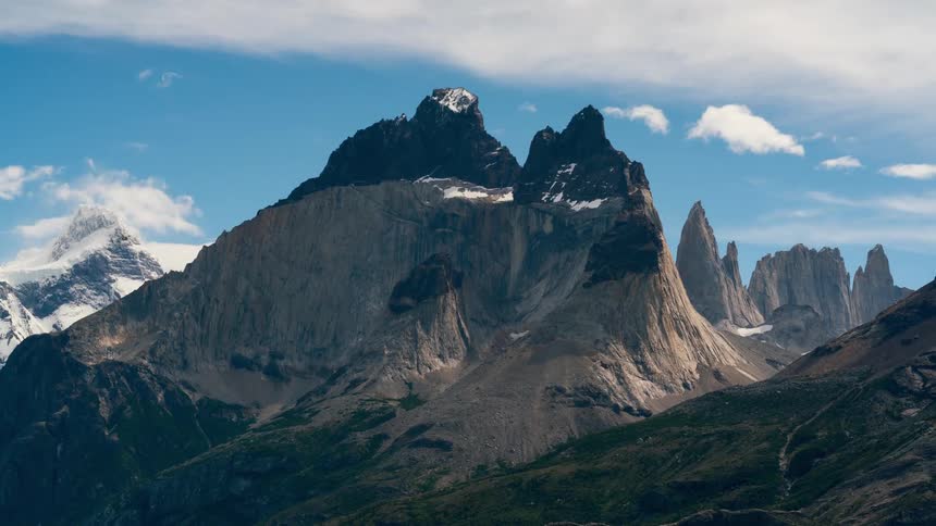 The iconic torres del paine in patagonia with their jagged peaks reaching towards a clear blue sky