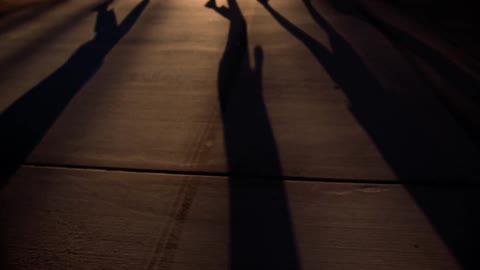 Elongated shadows cast on a floor