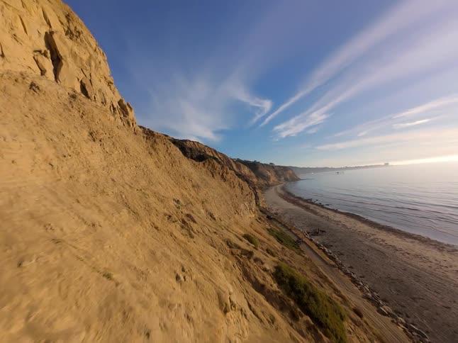 Aerial view of a sandstone cliff next to a beach