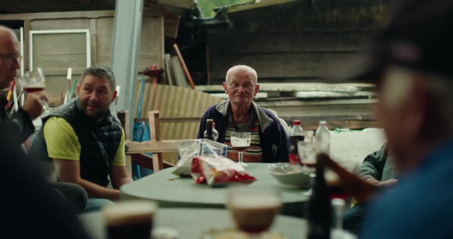 Group of male friends sitting at a table eating and drinking