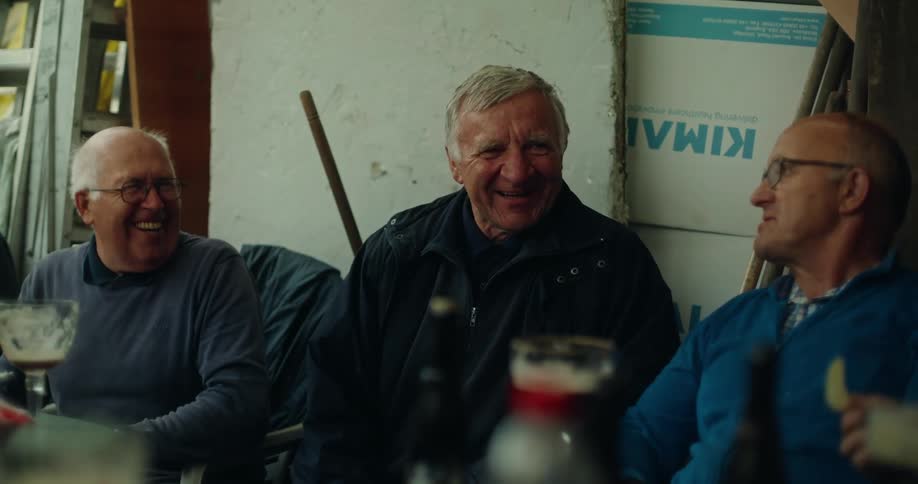 Group of men sitting talking and laughing