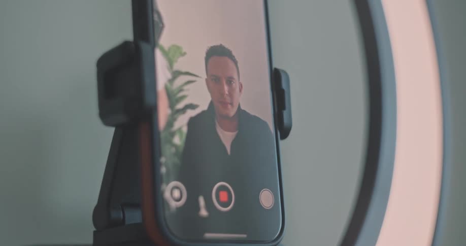 A man presses record on his cell phone
