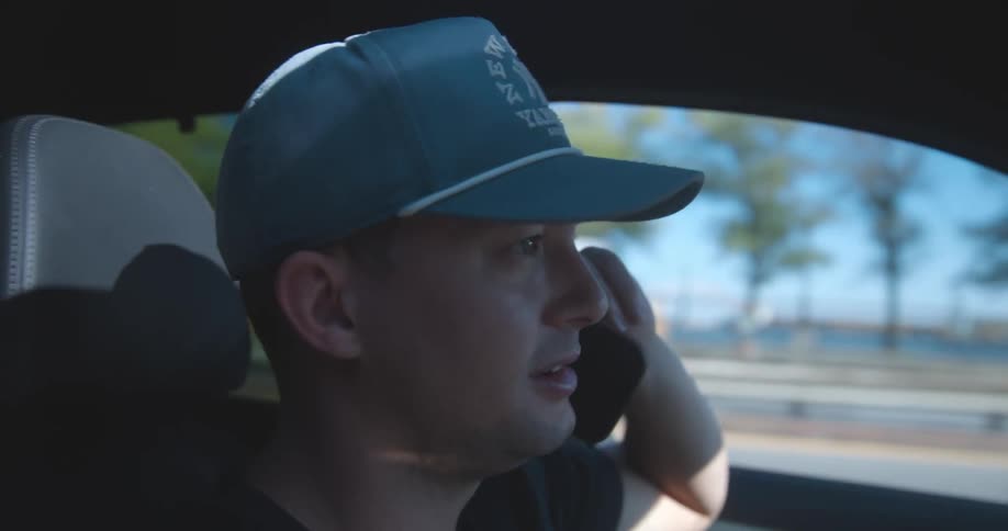 A clip of a person driving and making a phone call